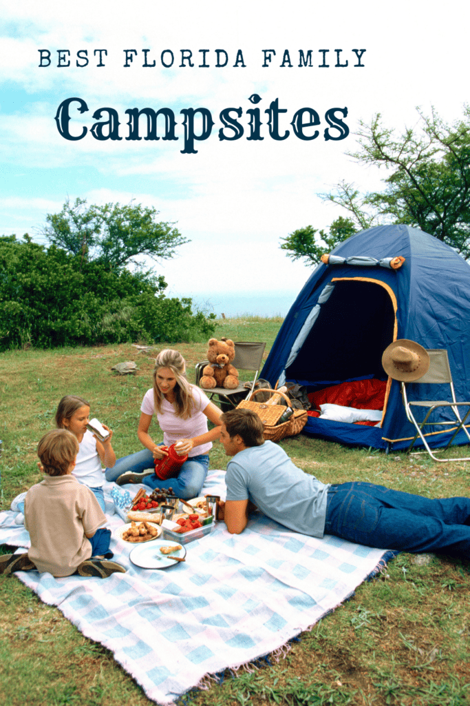 A family enjoys a picnic outside a navy and orange tent, with a spread of food on a blue checkered blanket, under the title 'Best Florida Family Campsites' with a backdrop of greenery.