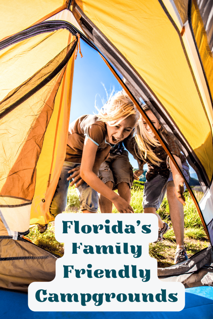 Two children gleefully emerge from a yellow and brown tent on a bright sunny day, with the text 'Florida’s Family Friendly Campgrounds' in playful font across the bottom.